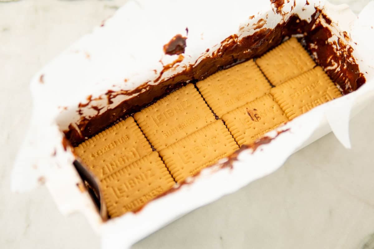 layering cookies and chocolate layer in a loaf pan