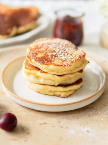 Closeup of a stack of fluffy German pancakes made with yeast.