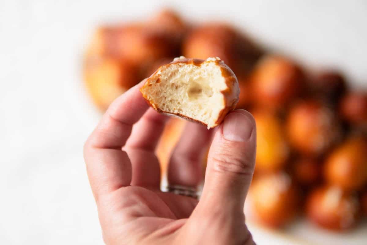 pretzel bite with one bite taken out of it