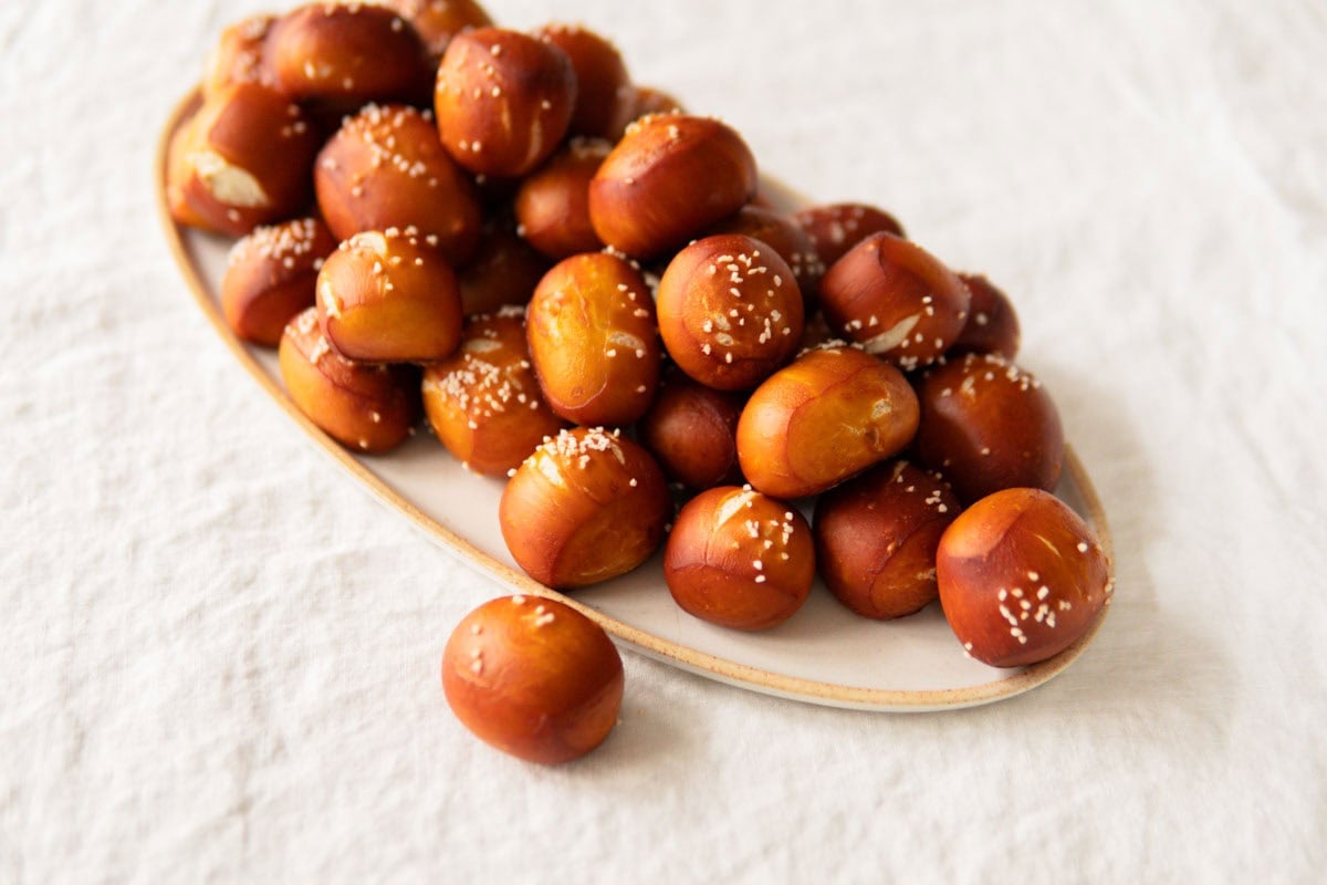 Pretzel bites on a white platter.