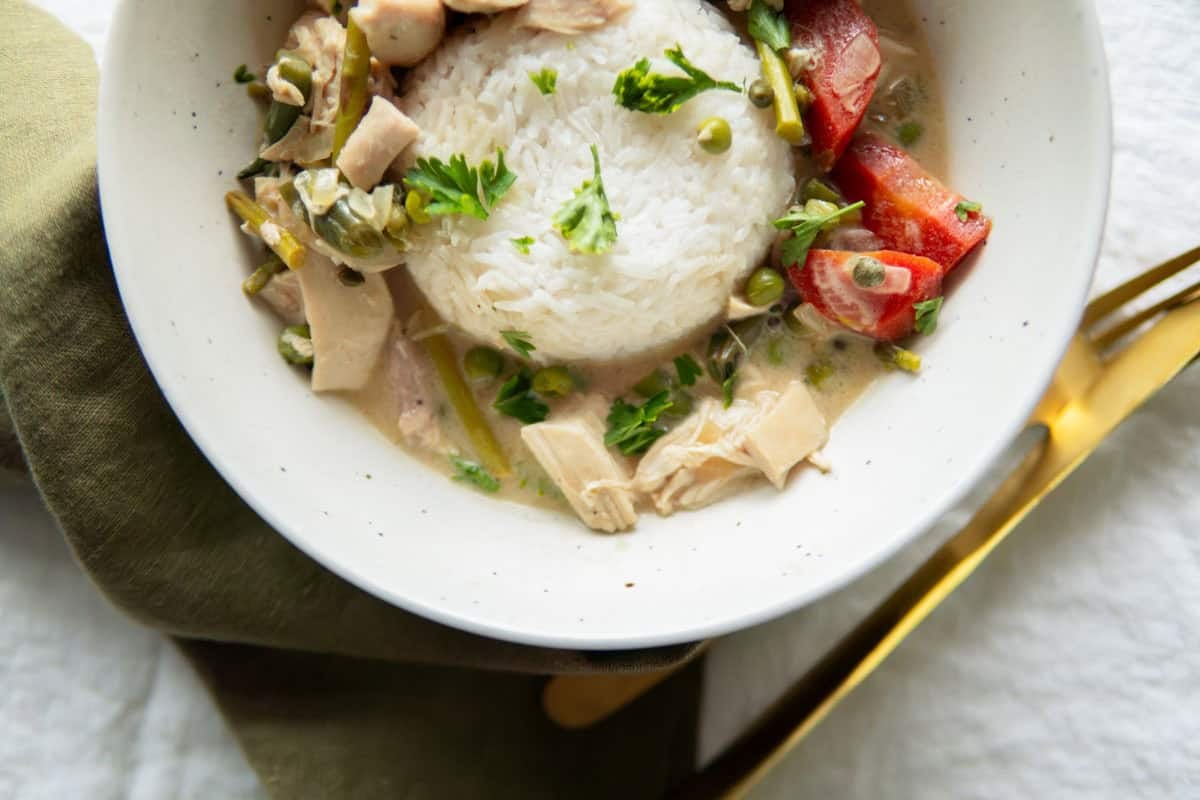 German stewed veggies and chicken over rice in a bowl.